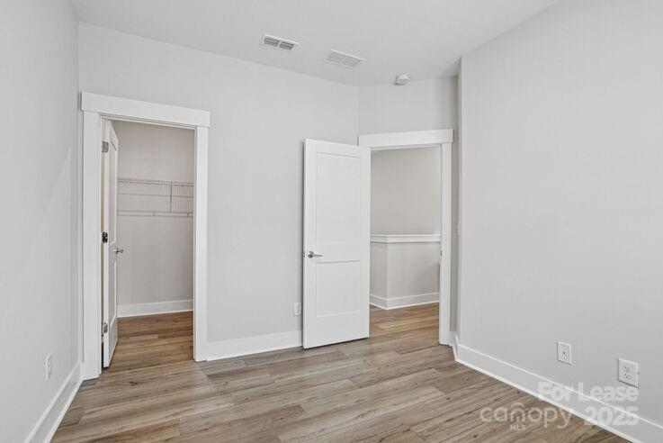 4375 Raleigh Street, Unit B1 Charlotte, NC 28213 - Photo 15 of 19 a view of an empty room with wooden floor