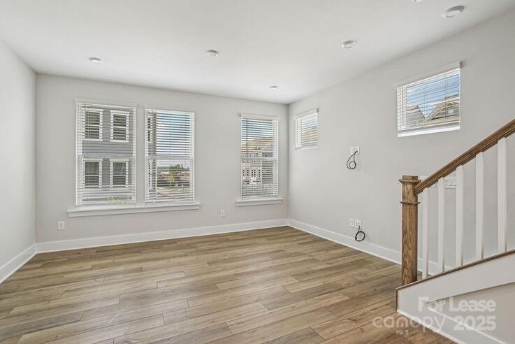 4375 Raleigh Street, Unit B1 Charlotte, NC 28213 - Photo 10 of 19 a view of an empty room with wooden floor and a window
