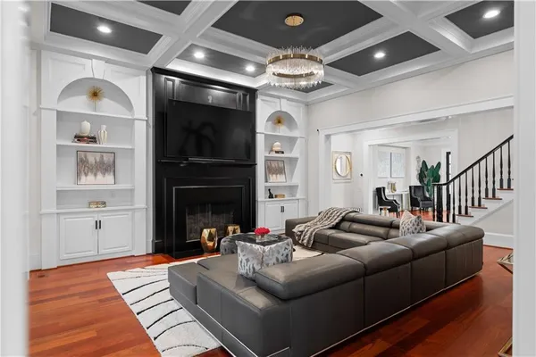 a view of walk in closet with wooden floor and stairs