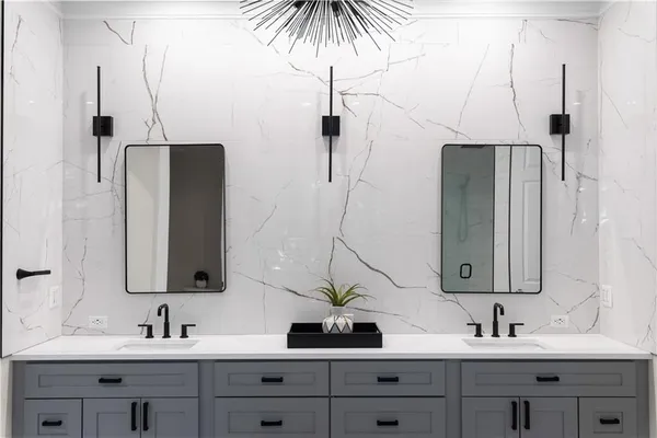 a bedroom with a bed and a flat tv screen on dresser