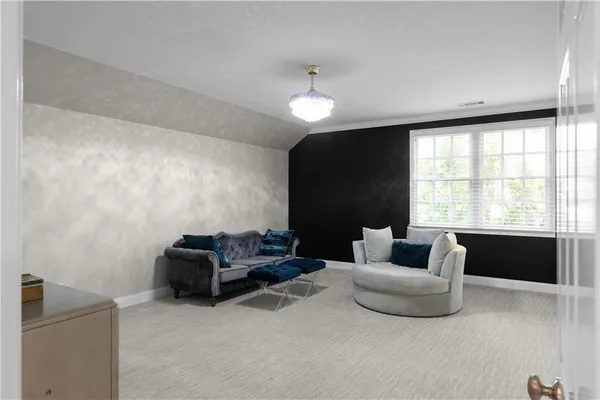a living room with furniture and a view of kitchen