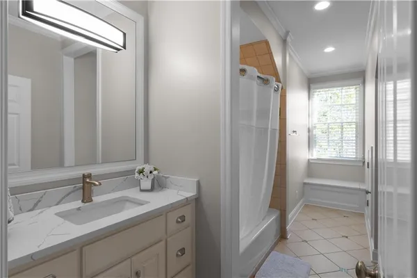 a living room with furniture floor to ceiling window and a potted plant