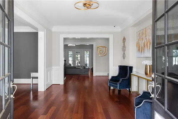 a dining room with furniture window and wooden floor