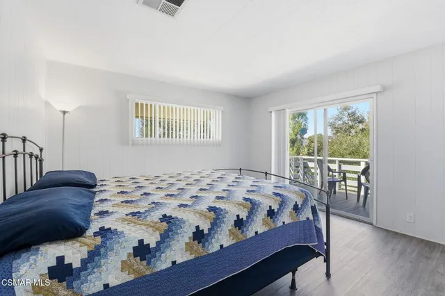 a bedroom with a bed a table and chair