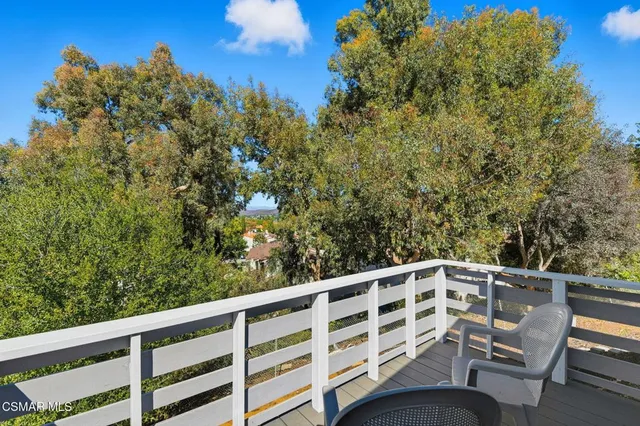 a view of a two chairs in the balcony