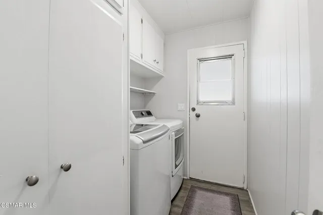 a view of a storage & utility room with a washer dryer