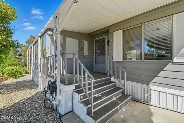 a view of wooden house with a large window