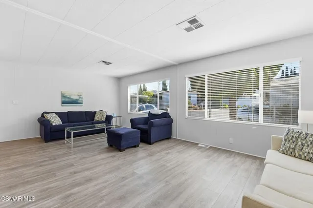 a living room with furniture and windows