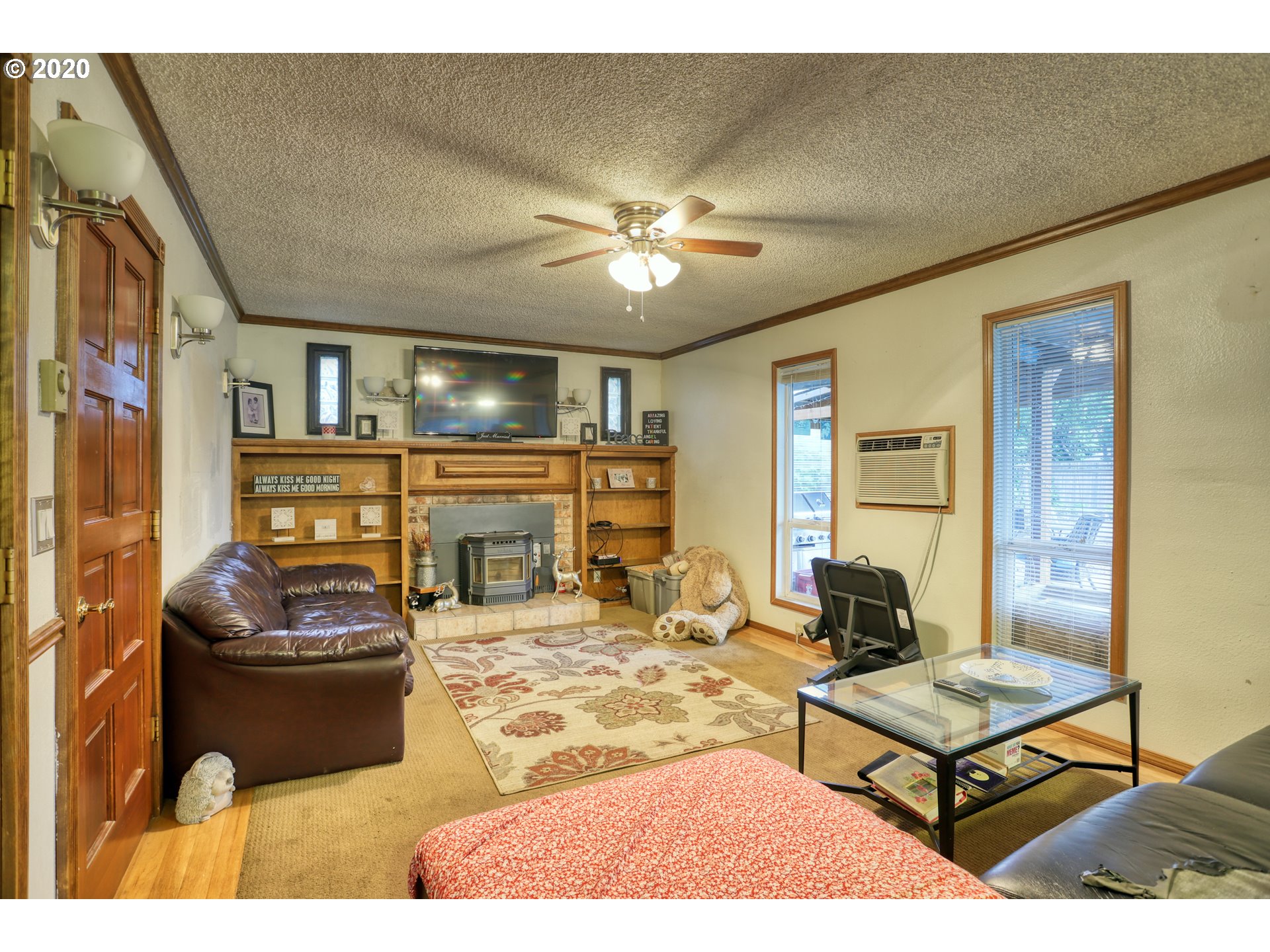 356 71st Street Springfield, OR 97478 - Photo 11 of 32 a living room with furniture a chandelier and a fireplace