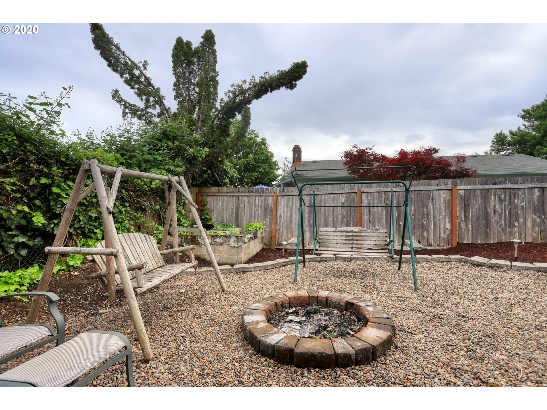 356 71st Street Springfield, OR 97478 - Photo 22 of 32 a backyard of a house with garden and outdoor seating