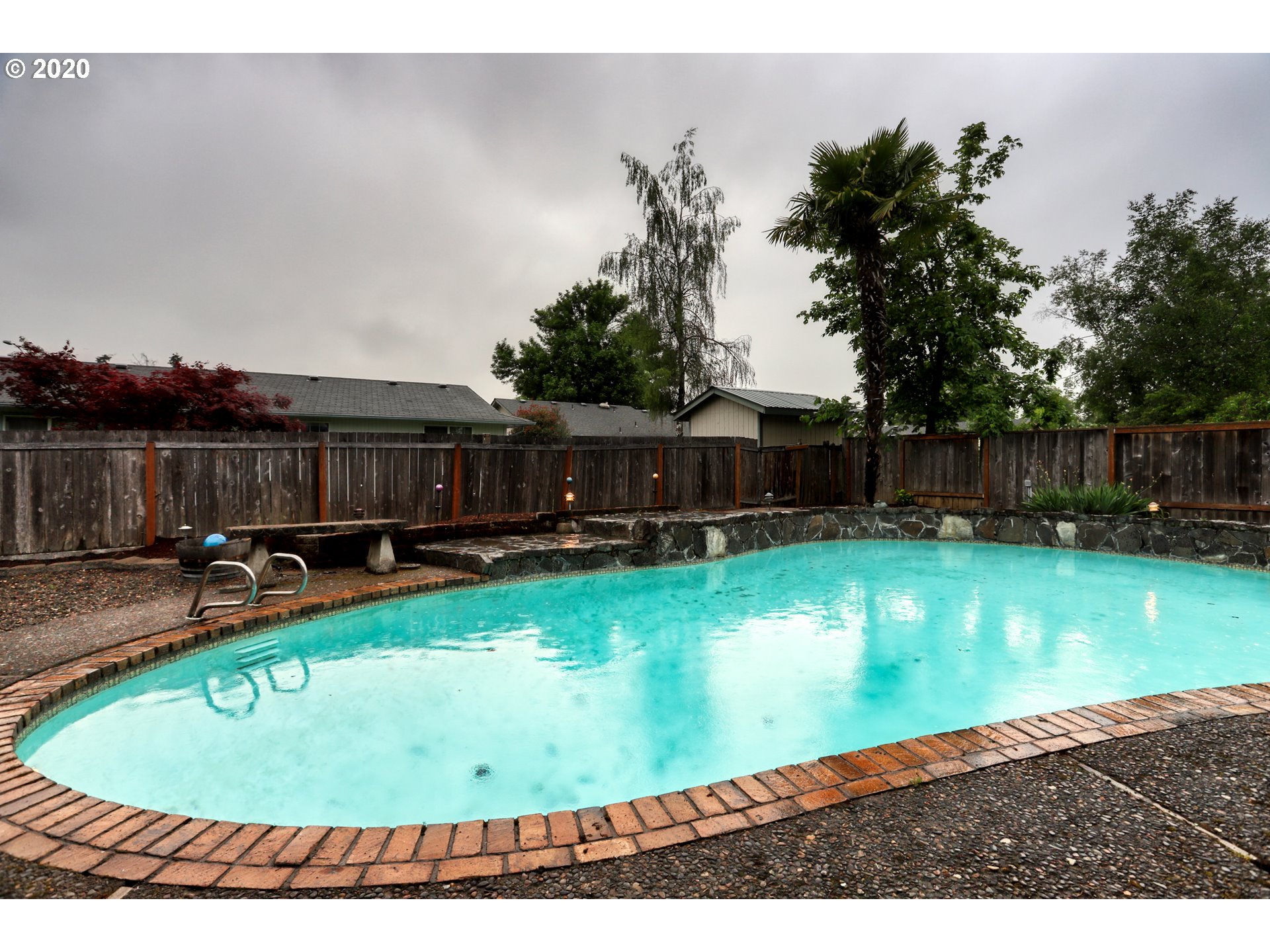 356 71st Street Springfield, OR 97478 - Photo 23 of 32 a view of a swimming pool with a yard and sitting area