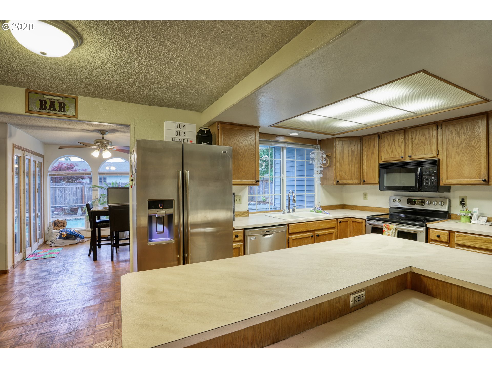 356 71st Street Springfield, OR 97478 - Photo 7 of 32 a kitchen with stainless steel appliances granite countertop a refrigerator a sink and a stove