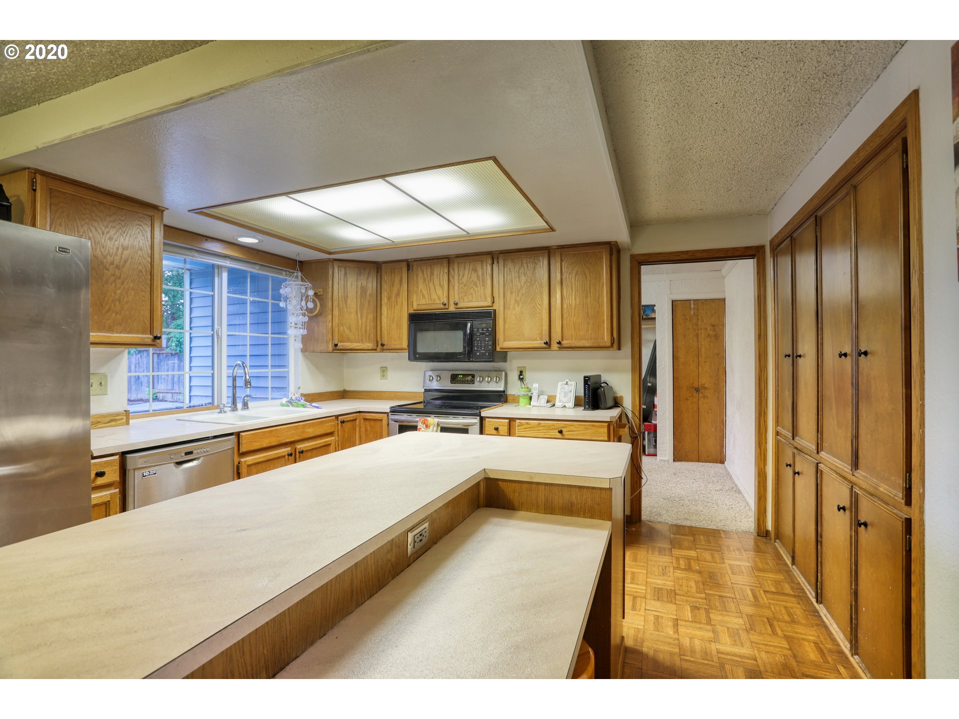 356 71st Street Springfield, OR 97478 - Photo 8 of 32 a large kitchen with stainless steel appliances kitchen island granite countertop a refrigerator and a stove top oven