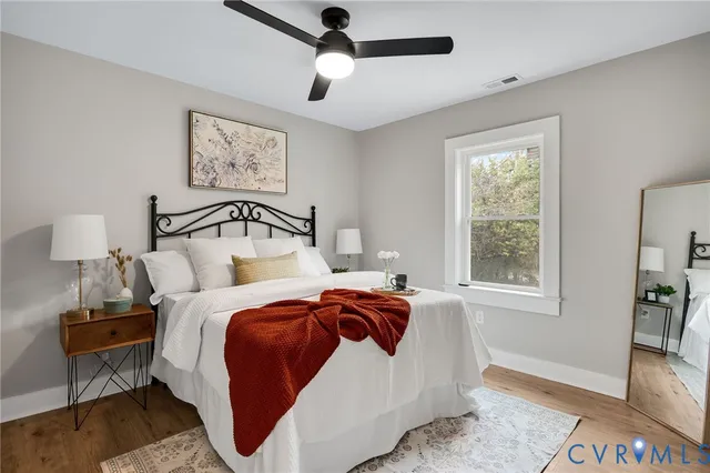 a bedroom with a bed and a large mirror