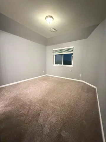 a view of a livingroom with a ceiling fan and window