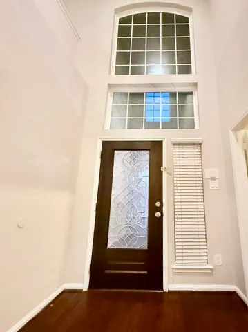 a view of wooden door and a window