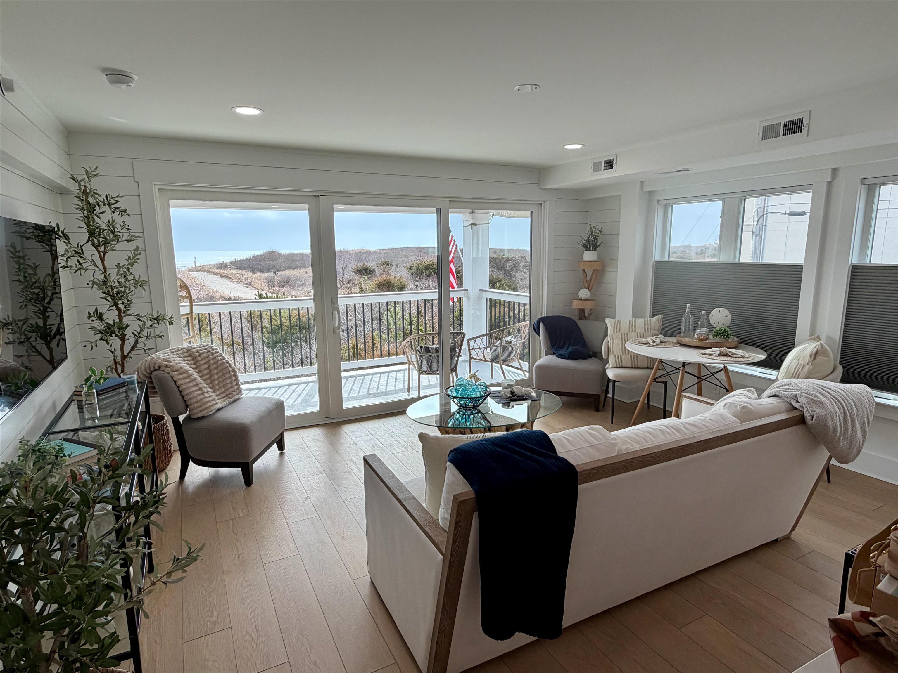 321 6th Street South, Unit 4 Brigantine, NJ 08203 - Photo 25 of 26 a living room with furniture and a flat screen tv