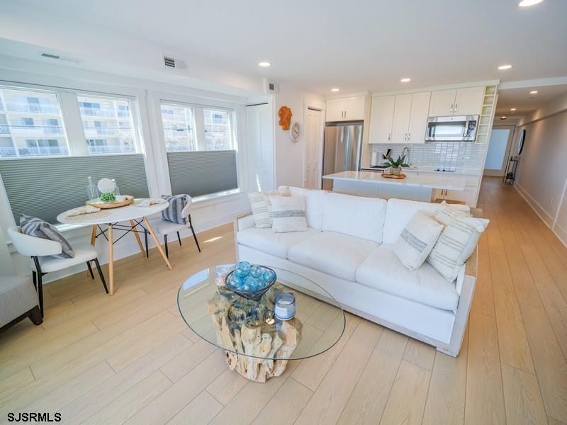321 6th Street South, Unit 4 Brigantine, NJ 08203 - Photo 3 of 26 a living room with furniture kitchen view and a wooden floor