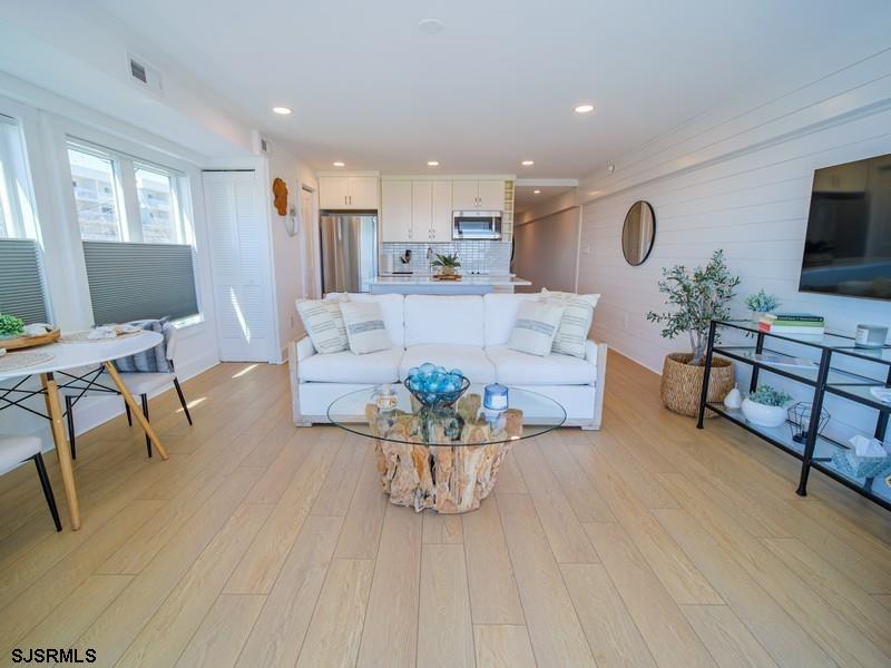 321 6th Street South, Unit 4 Brigantine, NJ 08203 - Photo 4 of 26 a living room with furniture and a flat screen tv