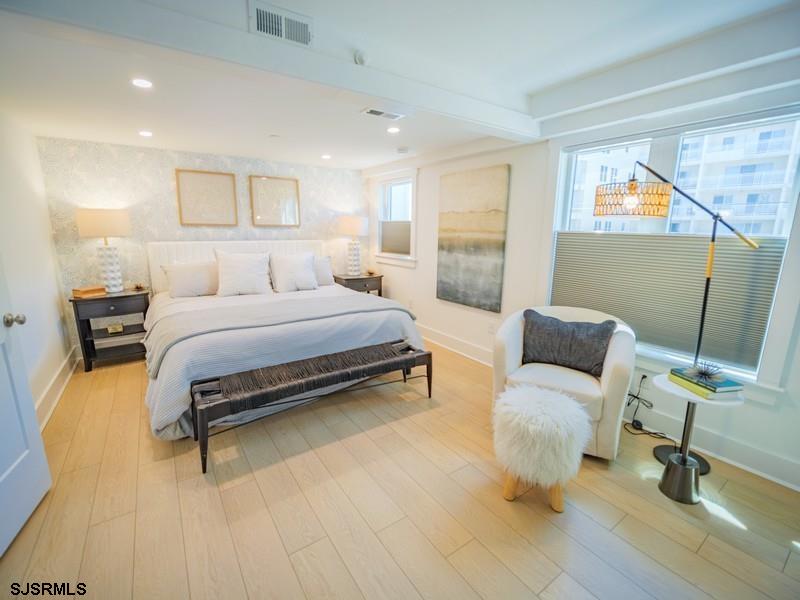321 6th Street South, Unit 4 Brigantine, NJ 08203 - Photo 9 of 26 a bedroom with a bed and wooden floor