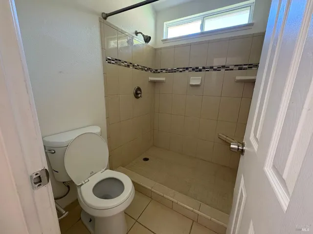 a bathroom with a toilet and a shower