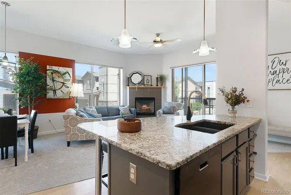a kitchen with stainless steel appliances granite countertop a sink and a refrigerator