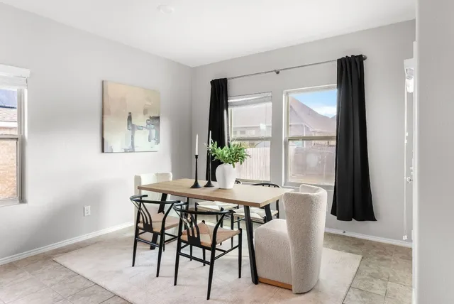 a view of a dining room with furniture and window