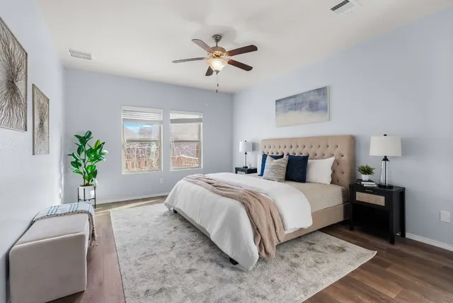 a spacious bedroom with a bed and a couch