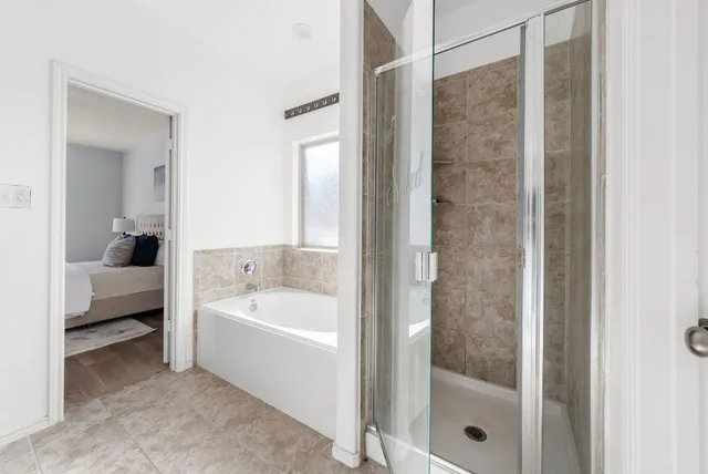 a bathroom with a bathtub and a shower