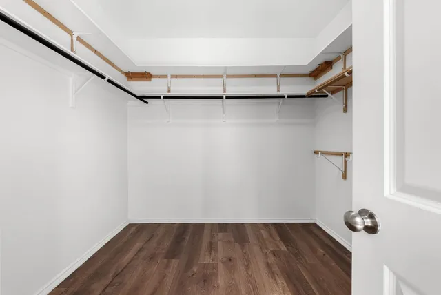 a view of a room with wooden floor