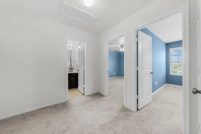 an empty room with a bathroom and a sink