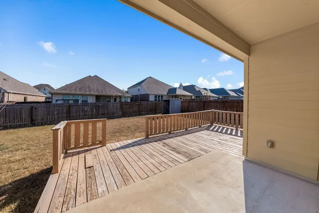 a view of balcony with wooden floor and a potted plant