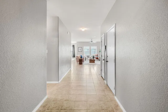 a view of a hallway with a living room