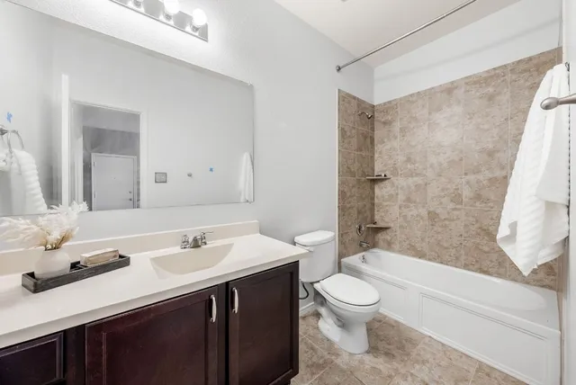 a bathroom with a sink a toilet and a bathtub