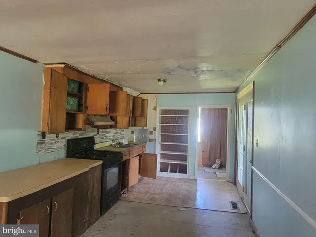 a view of a kitchen with refrigerator and a sink