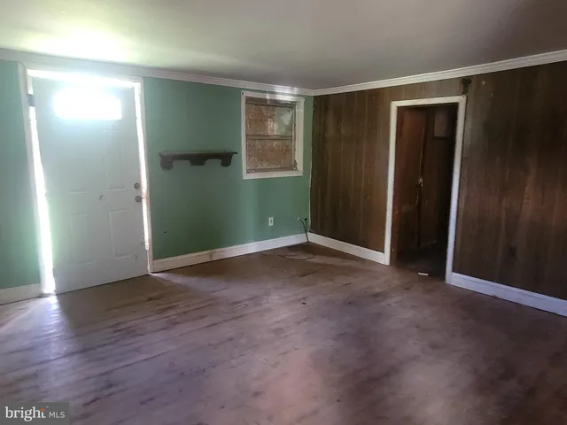 an empty room with closet and wooden floor