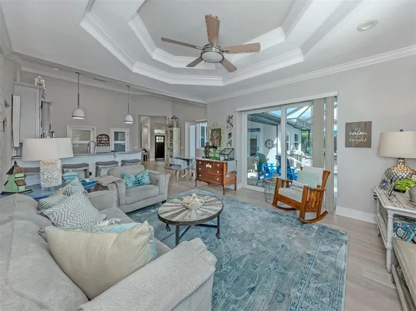 a living room with furniture and a chandelier