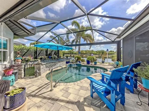 a view of patio with a table and chairs under an umbrella