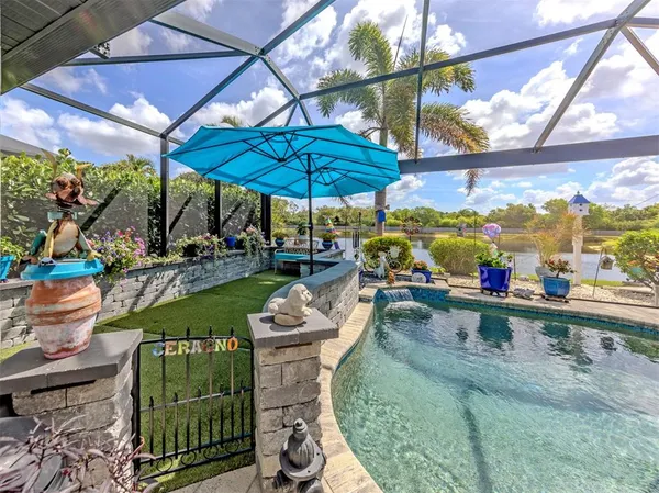 a view of a patio with table and chairs under an umbrella