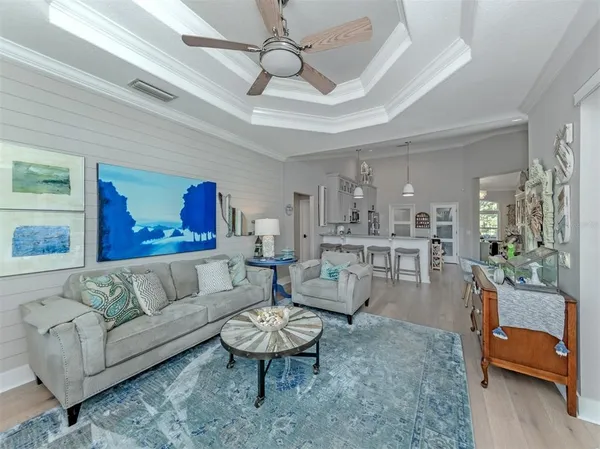 a living room with furniture and a chandelier