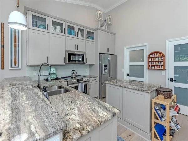 a kitchen with stainless steel appliances granite countertop a sink stove and refrigerator