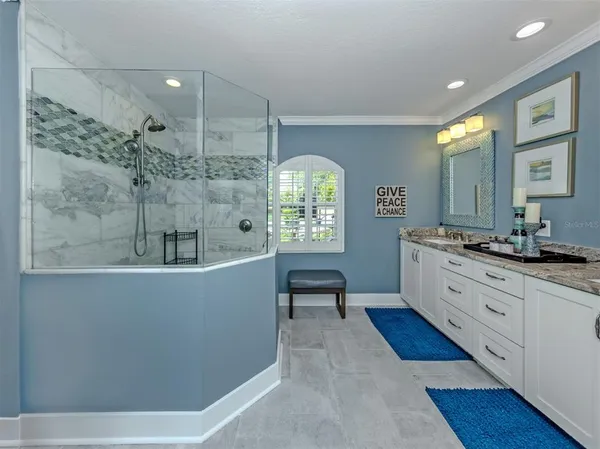 a large bathroom with a large mirror vanity and a sink