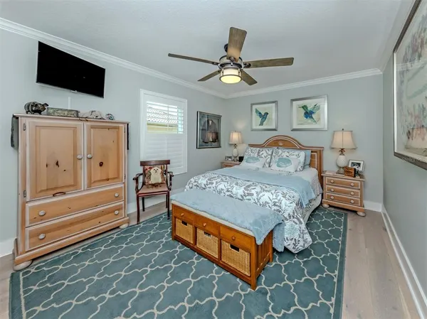 a bedroom with a bed and flat screen tv