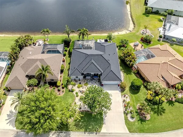 an aerial view of a house with a yard swimming pool and outdoor seating