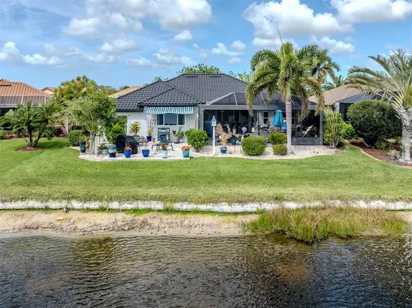 a view of a house with swimming pool and a yard