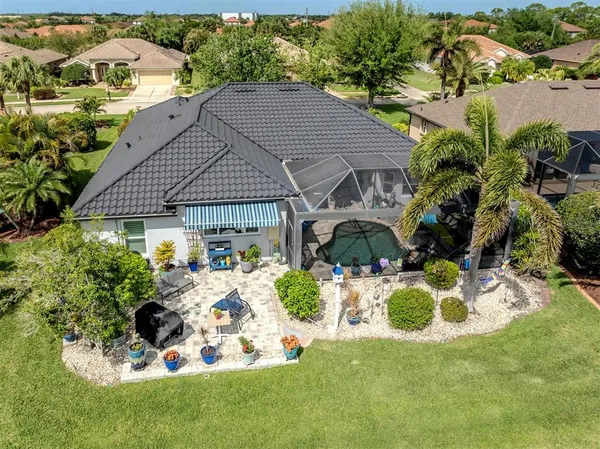 a aerial view of a house with yard and lake view