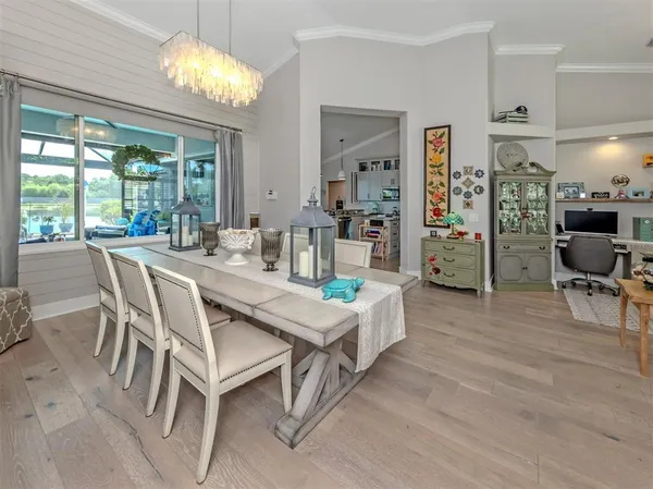 a view of a dining room with furniture wooden floor and chandelier