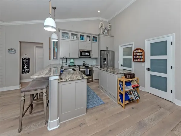 a kitchen that has a lot of cabinets a sink and appliances in it