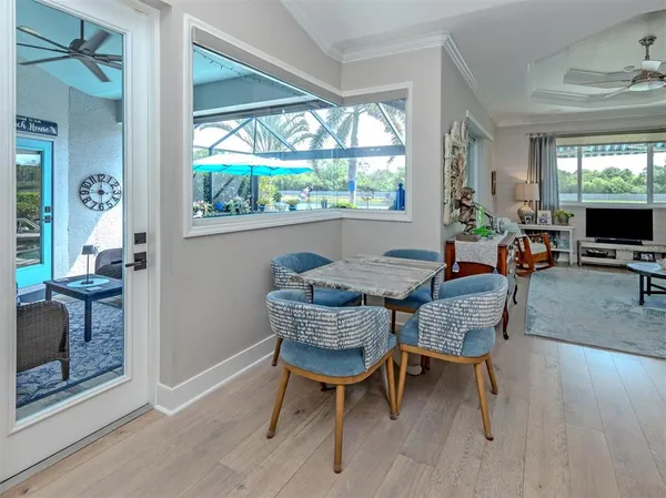a dining room with furniture and wooden floor