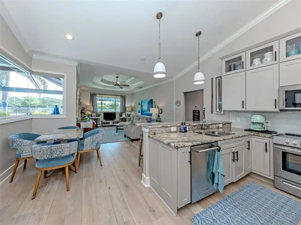 a kitchen with stainless steel appliances granite countertop a stove and a wooden floors